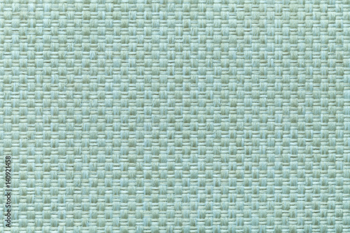Light cyan textile background with checkered pattern, closeup. Structure of the fabric macro.
