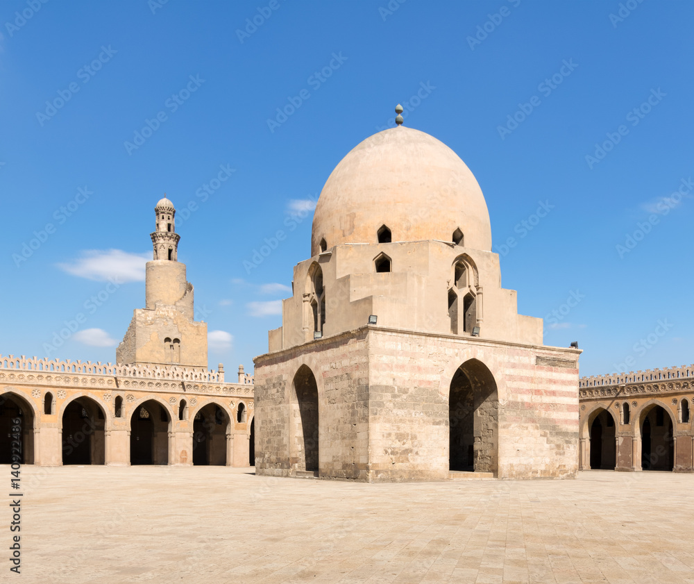 Courtyard of Ibn Tulun Mosque, Cairo, Egypt. View showing the ablution fountain and the minaret. The mosque is the largest one in Cairo, and may be the oldest mosque in the city with its original form