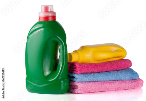 bottle laundry detergent and conditioner or fabric softener with towels isolated on white background
