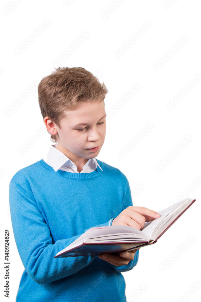 Reading young boy in blue pullover with book. Schoolboy with pancil isolated on white background. Reading young boy in blue pullover with book. Schoolboy with pancil isolated on white background.