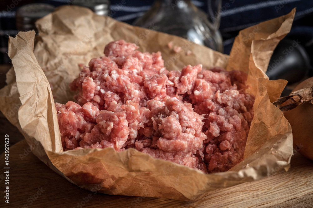 Minced meat on wooden background.