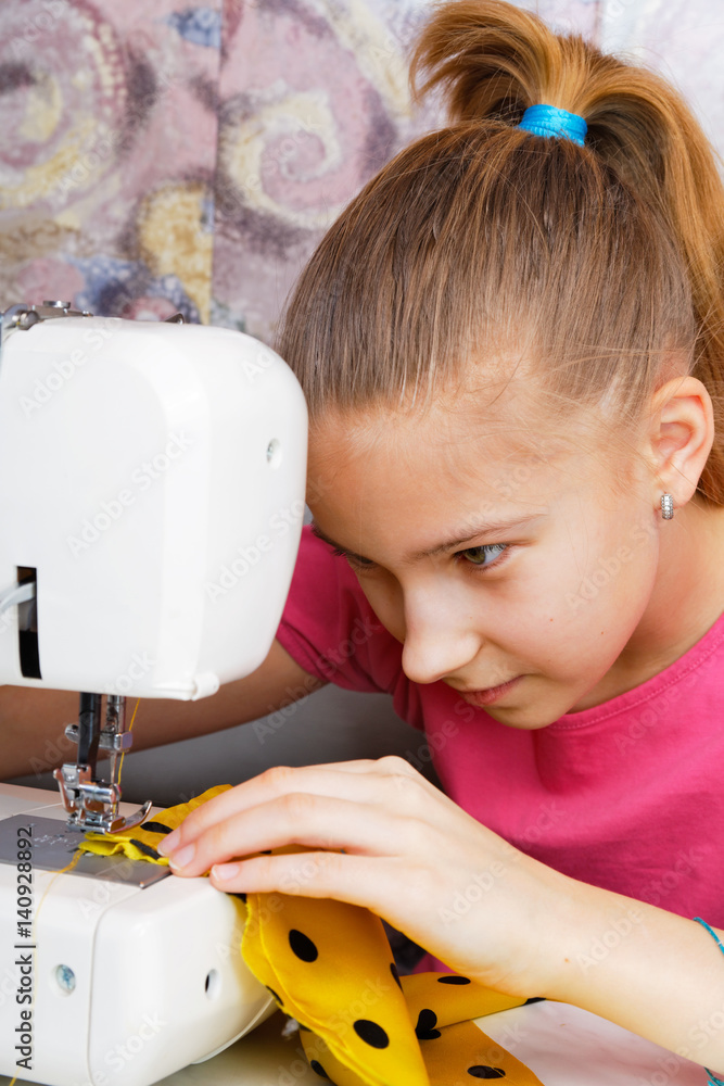 Girl learns to sew