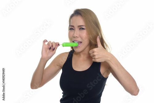 woman eating ice lolly, isolated on white background.