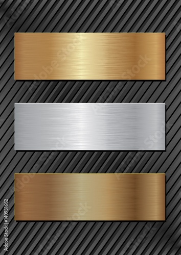 Three metal plaques on black background.