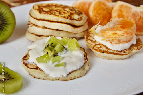 pancakes on a white plate with fruit