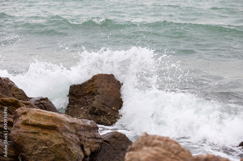 Splashes from the waves on the stone beach