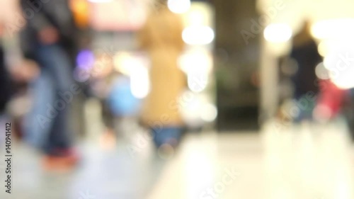 Blur bokeh of people walking in train station in the UK.