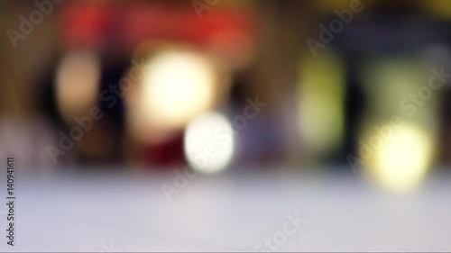 Blur bokeh of people walking in train station in the UK.