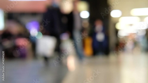 Fast forward Blur bokeh of people walking in train station in the UK.