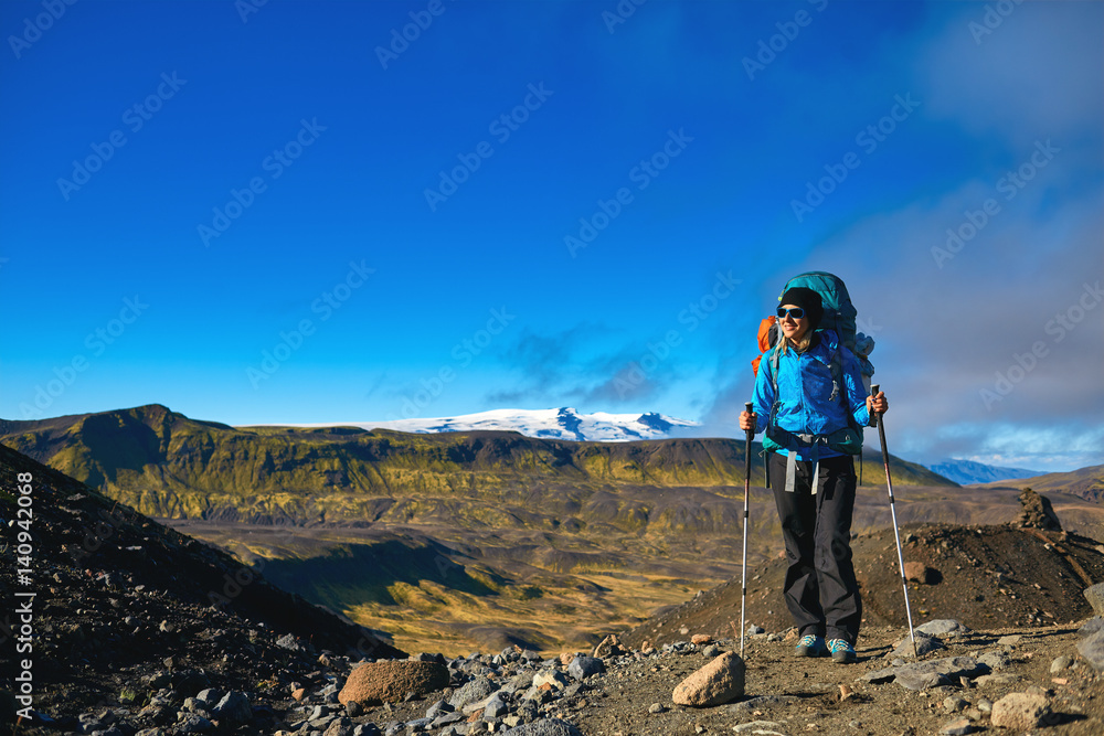 woman hiker on the trail in the Islandic mountains. woman standing and posing against the backdrop of a desert mountain landscape. Treking in National Park Landmannalaugar, Iceland. Travel photography