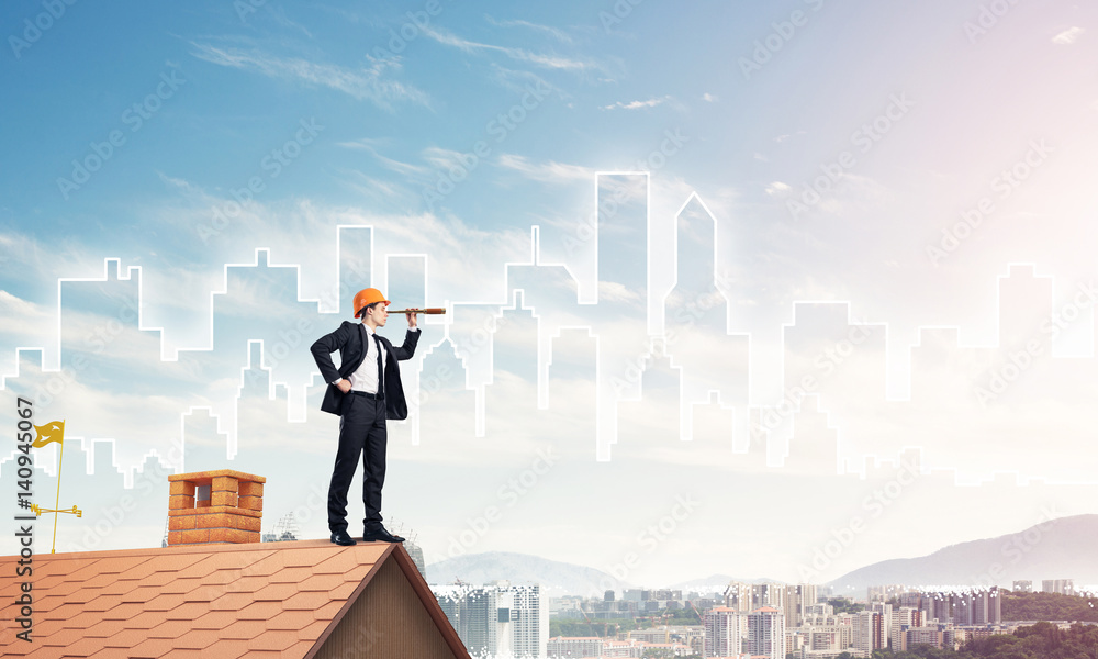 Engineer man standing on roof and looking in spyglass. Mixed med Engineer man standing on roof and looking in spyglass. Mixed med