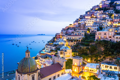 Positano, Amalfi Coast, Campania, Sorrento, Italy. View of the town and the seaside in a summer sunset photo