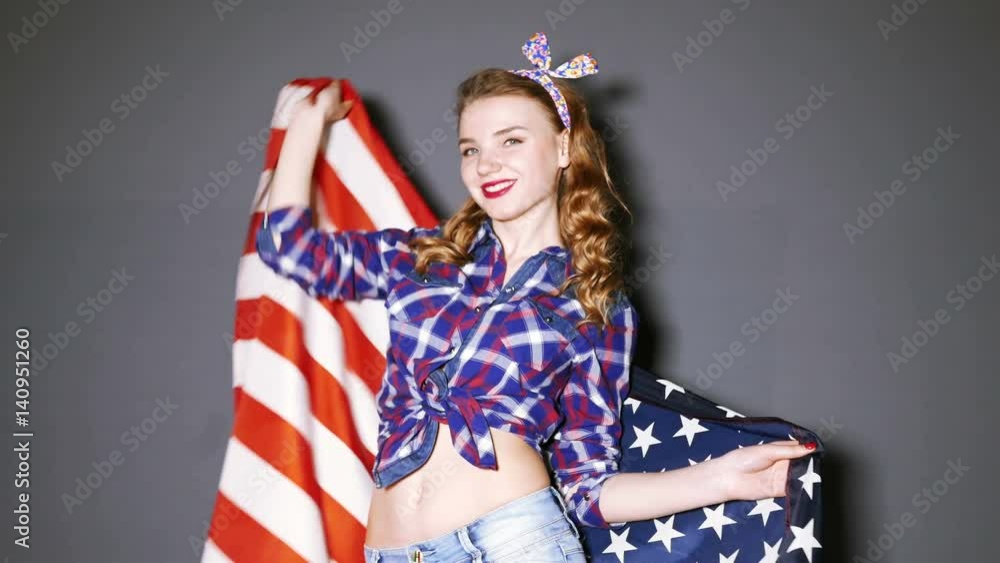 4K. Sexy young girl dances with American flag and smile. 4K. Sexy young girl dances with American flag and smile.
