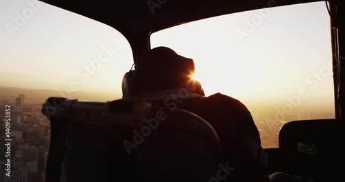 Slow motion, Helicopter interior view, fly over Los Angeles at sunset