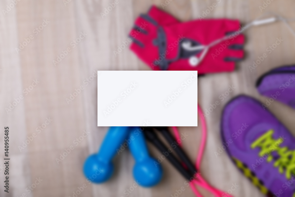Business card mockup. Fitness gym equipment. Sneakers, dumbbells with skipping rope. Workout gloves and footwear. Business card mockup. Fitness gym equipment. Sneakers, dumbbells with skipping rope. Workout gloves and footwear.