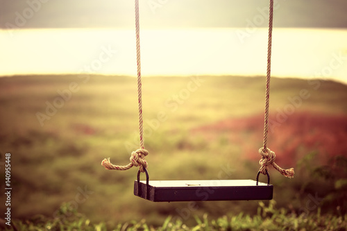 Children swing in the park (vintage tone) photo