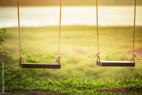 Children swing in the park (vintage tone)
