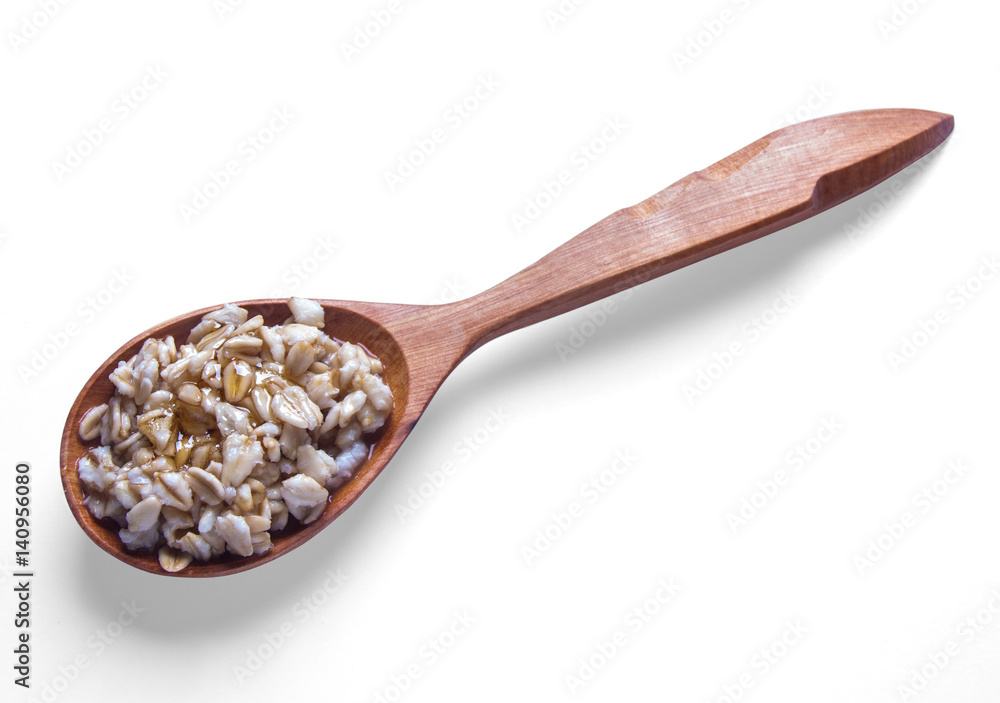 Spoon of oats porridge on a white background. Spoon of oats porridge on a white background.