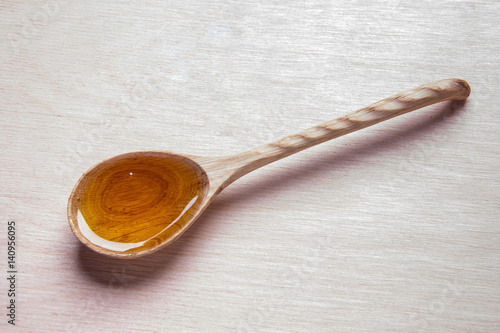 wooden spoon and honey isolated on white background
