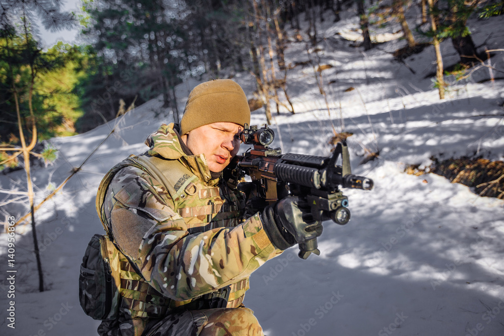 Fototapeta premium team of special forces weapons in cold forest. Winter warfare and military concept
