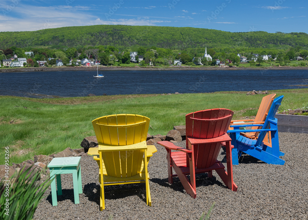 Fototapeta premium Adirondack chairs overlooking the Annapolis River in Nova Scotia, Canada.