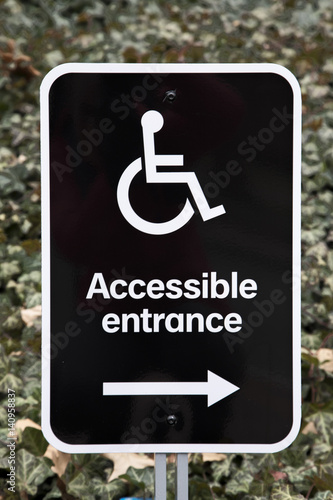 A black and white accessible entrance sign  photo