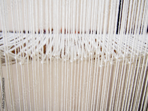 Closeup of Strands of White Yarn on Loom