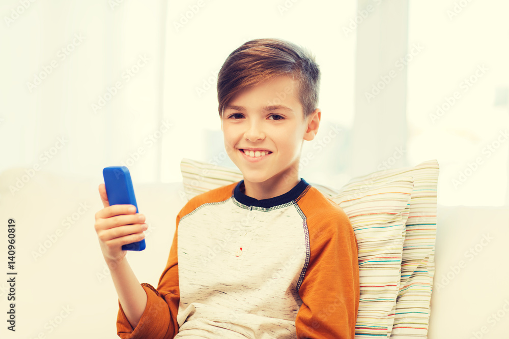 boy with smartphone texting or playing at home boy with smartphone texting or playing at home