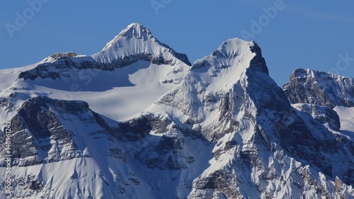 Snow covered peak of mount Uri Rotstock, Swiss Alps.
