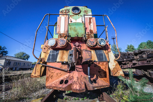 Rusty locomotive on deserted Yaniv railroad station near Pripyat city in Chernobyl Exclusion Zone, Ukraine