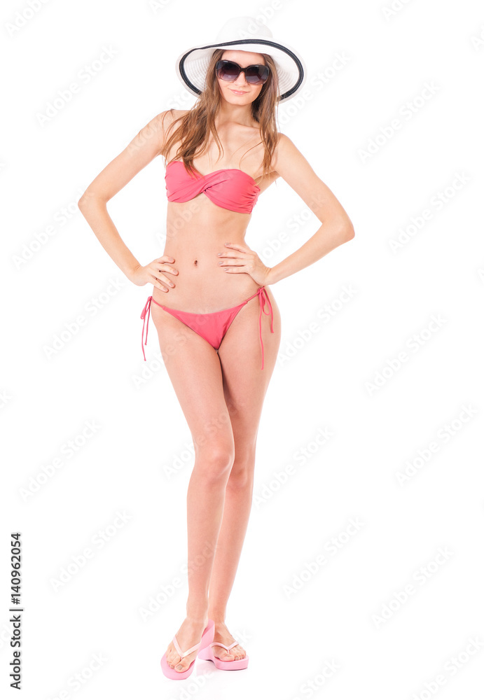 Fototapeta premium Sexy young woman posing in a bikini, isolated on white background 