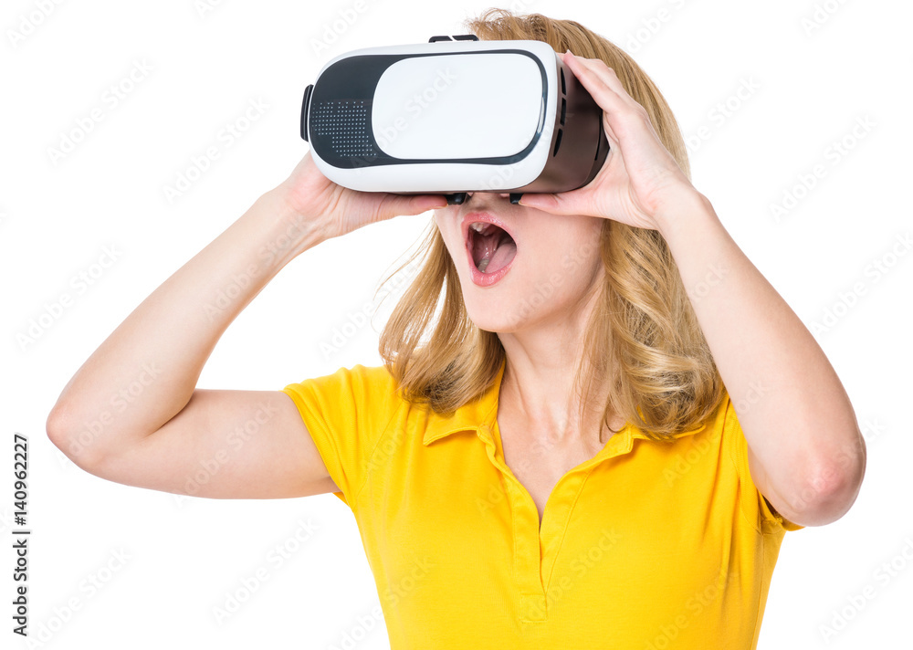Amazed woman wearing virtual reality goggles watching movies or playing video games, isolated on white background. Surprised girl looking in VR glasses. People experiencing 3D gadget technology. Amazed woman wearing virtual reality goggles watching movies or playing video games, isolated on white background. Surprised girl looking in VR glasses. People experiencing 3D gadget technology.