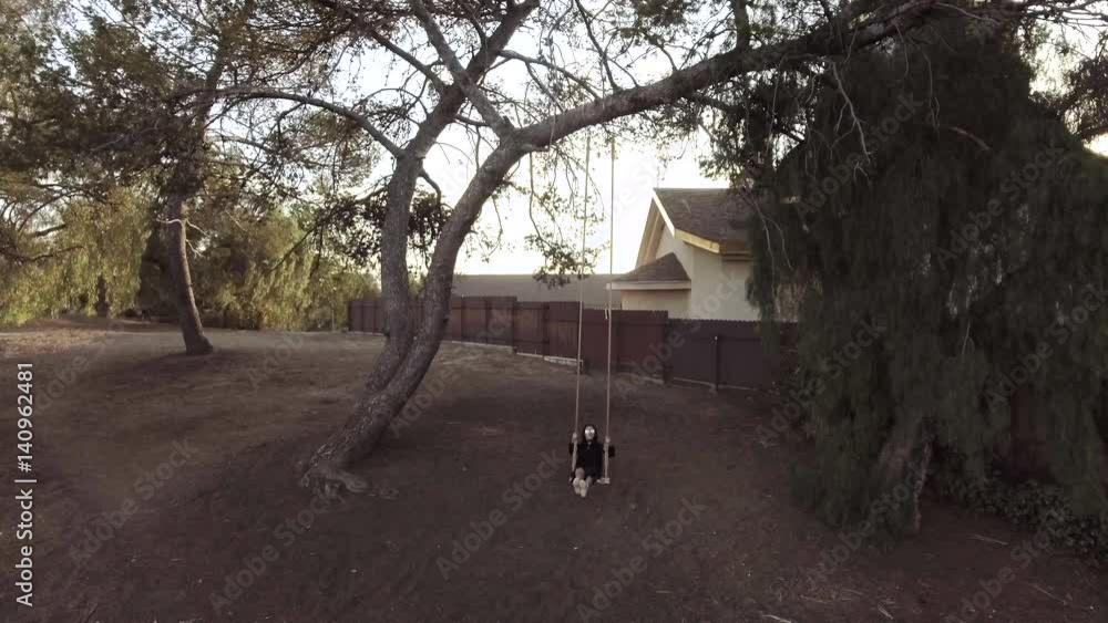 Woman swings on California hillside Woman swings on California hillside