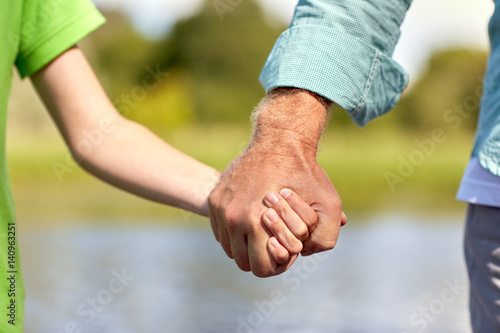 senior man and child holding hands