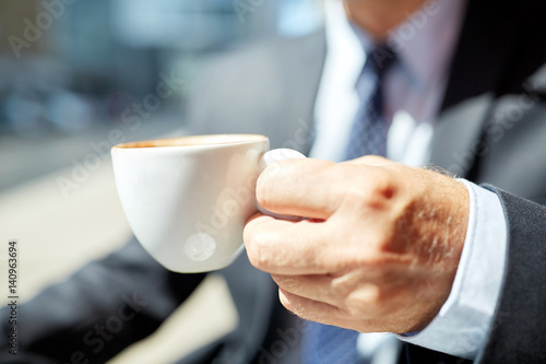 senior businessman hand with coffee cup outdoors