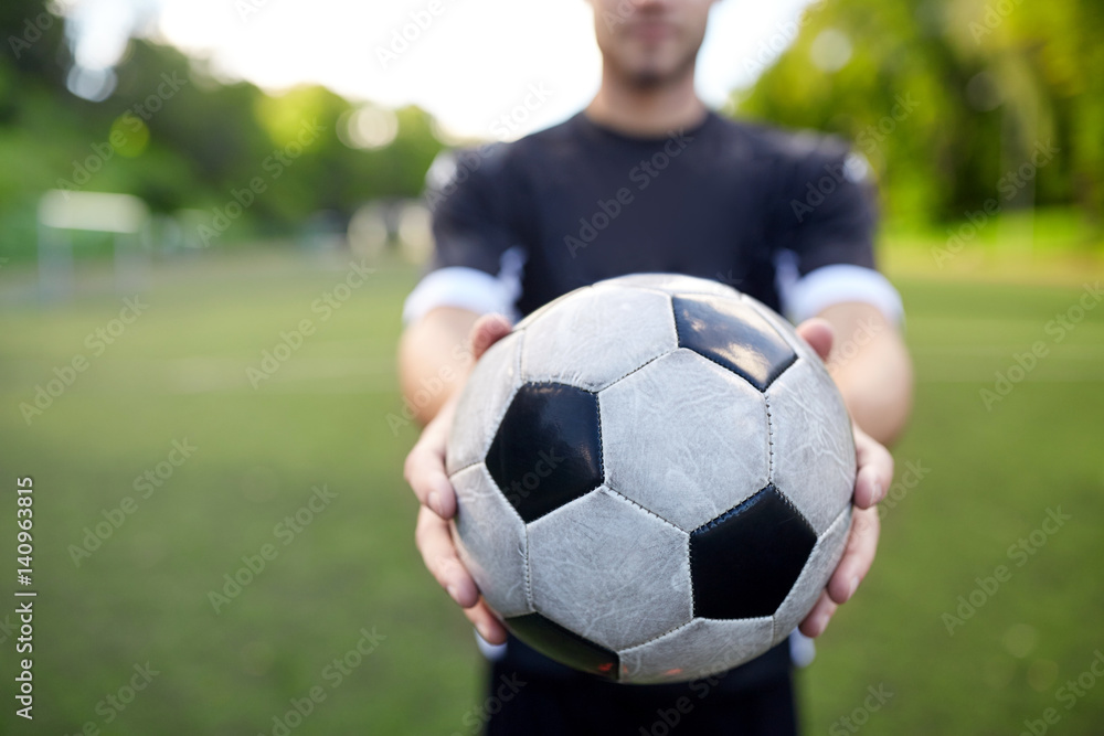 soccer player with ball on football field