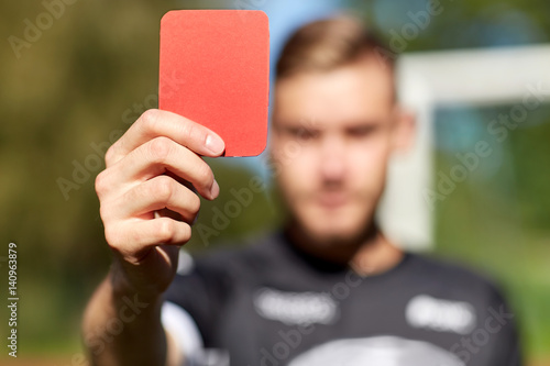 Obraz na plátne referee hands with red card on football field
