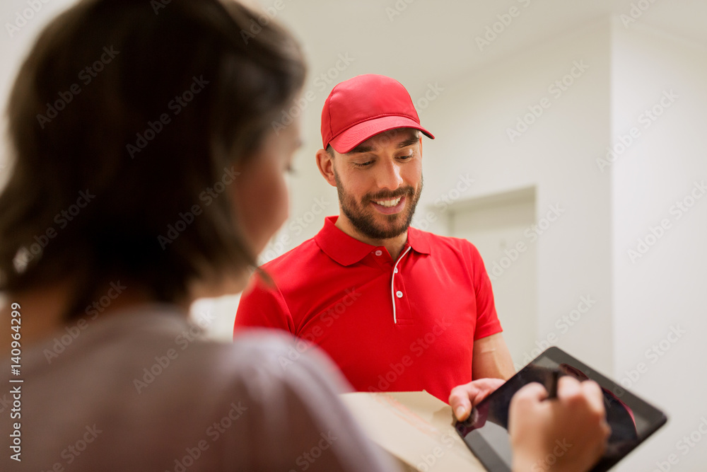 delivery man with box and tablet pc at customer delivery man with box and tablet pc at customer