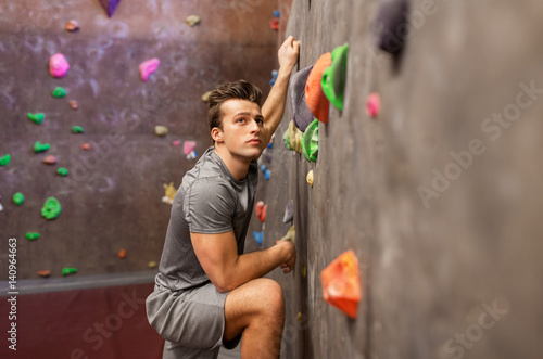 young man exercising at indoor climbing gym