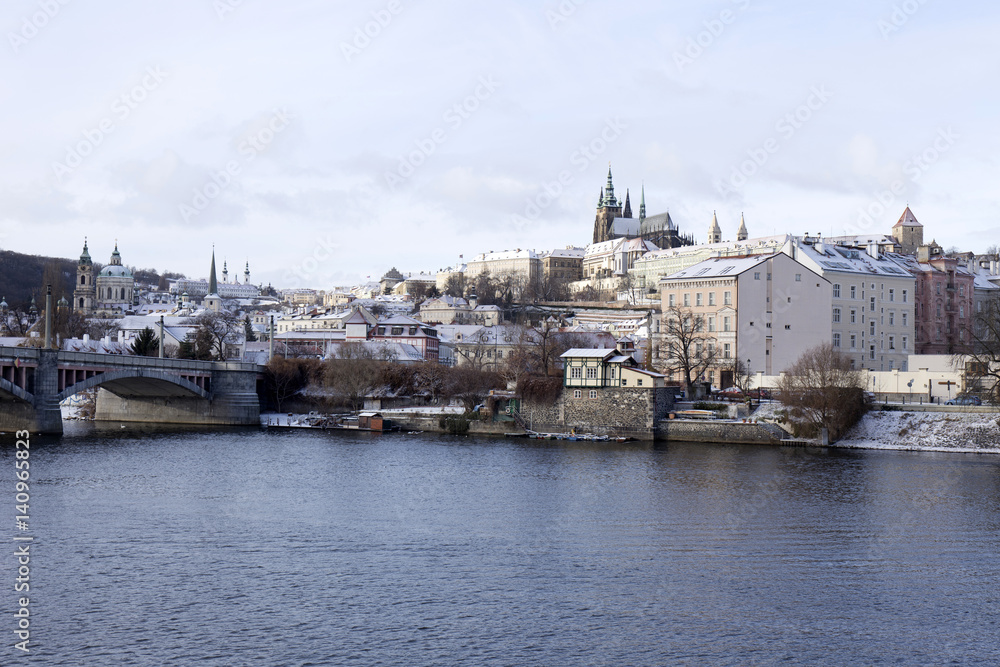 Obraz premium Snowy freeze Prague Lesser Town with gothic Castle, Czech republic