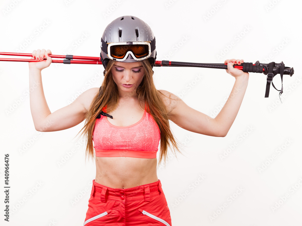 Woman wearing ski suit and helmet holding poles Woman wearing ski suit and helmet holding poles