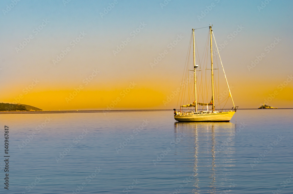 Yacht in the tropical sea at sunset Yacht in the tropical sea at sunset