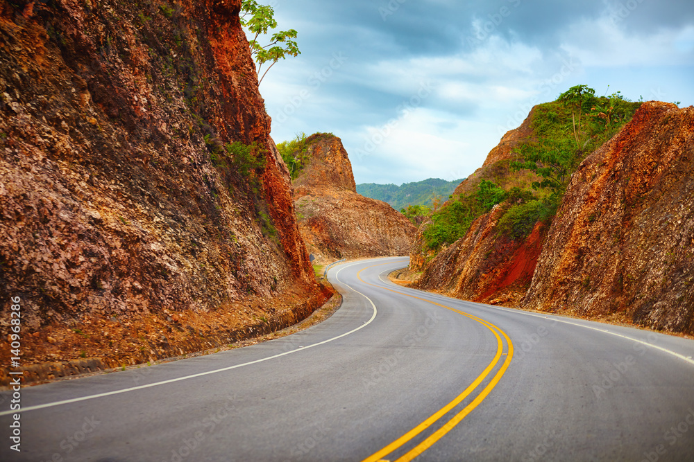 a highway to Samana Peninsula through rocky mountain. Boulevard Turistico Atlantico, 133. Dominican Republic - obrazy, fototapety, plakaty 