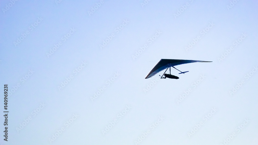 Obraz premium Glider silhouette flight over the clouds