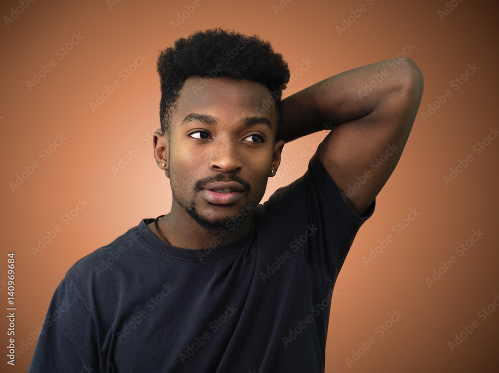 young man arm behind head orange studio background young man arm behind head orange studio background
