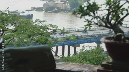 Movement of transport on the bridge over the river photo