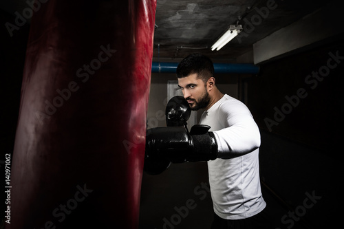 Portrait of young man practicing kickboxing at the gym