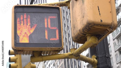 Pedestrian crossing light in big city goes from walk to do not walk in City.
