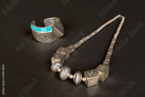 Antique Native American Sterling Silver Hollow-Form Cuff Bracelet and Necklace with Overlay and Turquoise Inlay on Black Background. photo