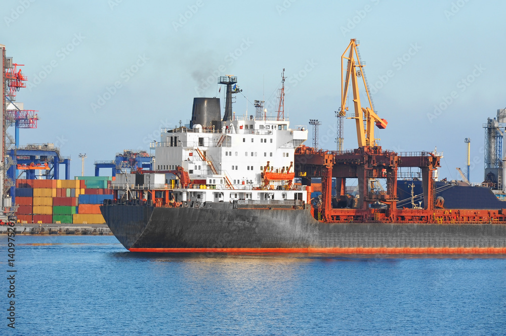 Bulk cargo ship under port crane Bulk cargo ship under port crane